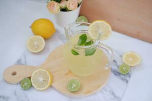 Lemonade with fresh lemon and mint leaves on a white background photo