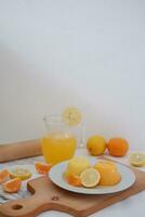 Orange jelly with fresh lemon and orange juice on a white background. photo