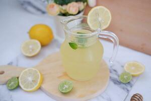 Lemonade with fresh lemon and mint leaves on a white background photo