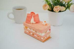 Slice of cake on white marble background. Selective focus. photo