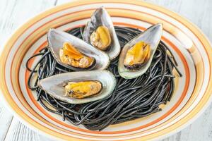 Black pasta with mussels photo