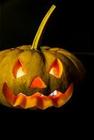 Glowing halloween pumpkin in candlelight photo