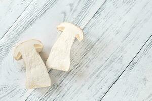 Halved porcini mushroom on the wooden background photo