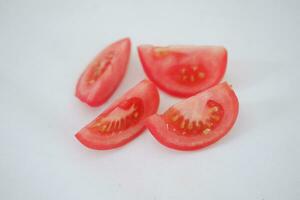 Tomatoes on a white background. Slices of tomatoes. photo