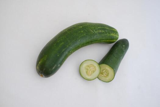 Cucumber and slices on a white background. Selective focus. photo