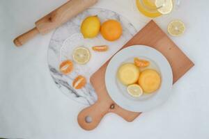 Orange jelly with fresh lemon and orange juice on a white background. photo