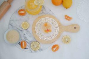 Yogurt with lemon, orange and grapefruit on white background photo