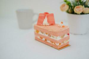 Piece of cake and cup of tea on white background, stock photo