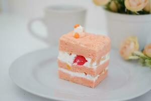 Slice of cake on white marble background. Selective focus. photo