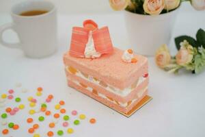 Slice of cake on white marble background. Selective focus. photo