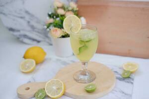 Lemonade with lime, mint and ice on a white background photo