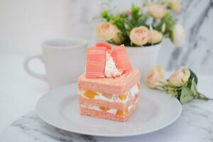 Slice of cake on white marble background. Selective focus. photo