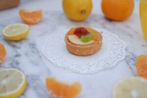 Fruit tartlet with orange, kiwi, strawberry and mandarin photo