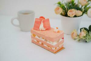 Slice of cake on white marble background. Selective focus. photo