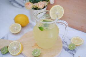 Lemonade with fresh lemon and mint leaves on a white background photo