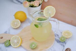 Lemonade with fresh lemon and mint leaves on a white background photo