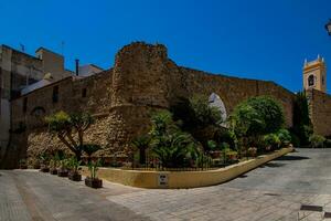 narrow streets of the old town in Calpe Spain on a summer hot holiday day photo