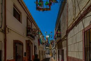 narrow streets of the old town in Calpe Spain on a summer hot holiday day photo