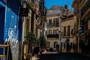 narrow streets of the old town in Calpe Spain on a summer hot holiday day photo