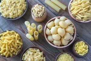 Various types of pasta on the white background photo