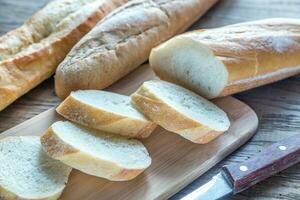 Three baguettes on the wooden background photo