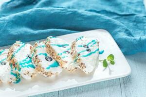 Sliced merengue roll with nuts photo