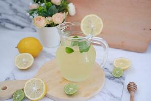 Lemonade with fresh lemon and mint leaves on a white background photo