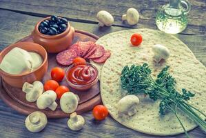 Ingredients for pizza on the wooden background photo