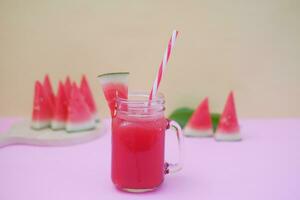 Watermelon smoothie in a glass jar with straws as a background photo