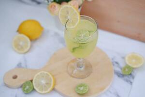 Lemonade with lime, mint and ice on a white background photo