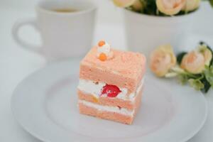 Piece of cake and cup of tea on white background, stock photo