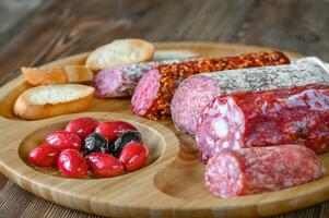 Assortment of salami with appetizers photo