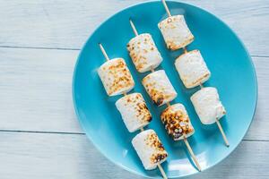 Marshmallow skewers on the plate photo