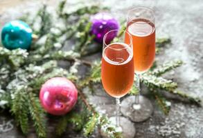 Two glasses of champagne with Christmas tree branch photo