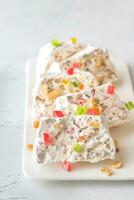 White nougat slices on white plate photo