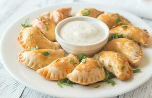 Mini chicken pies with creamy garlic sauce photo