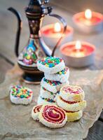 Heap of Turkish delight with burning candles photo