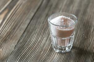 Glass of pink sea salt photo