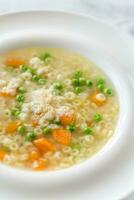 Italian chicken pasta soup with parmesan photo