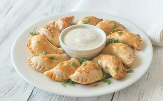 Mini chicken pies with creamy garlic sauce photo