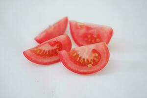 Tomatoes on a white background. Slices of tomatoes. photo