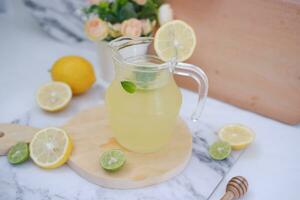 Lemonade with fresh lemon and mint leaves on a white background photo