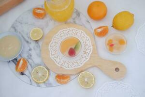 Fruit jelly with orange juice, lemon and kiwi on the table photo