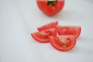 Tomatoes on a white background. Slices of tomatoes. photo