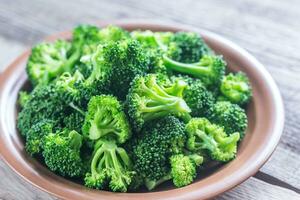 Cooked broccoli on the plate photo