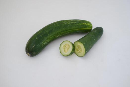 Cucumber and slices on a white background. Selective focus. photo