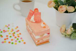 Slice of cake on white marble background. Selective focus. photo