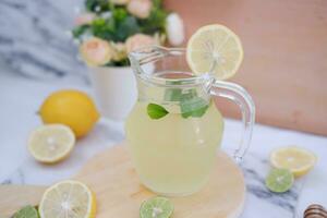 Lemonade with fresh lemon and mint leaves on a white background photo