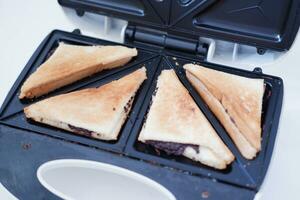 Toaster with toasted bread and chocolate in a white kitchen. photo