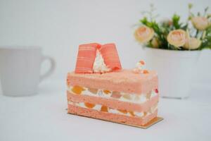 Piece of cake and cup of tea on white background, stock photo